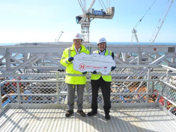 Robert Bertram, chief executive of the HELP Appeal and Duane Passman, director of the hospital redevelopment, on the helideck construction site