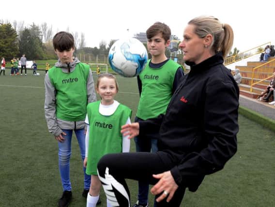 Former England captain Kelly Smith with Isabelle Cowen, eight, Elliot Hutton, 13, and his brother Jakob, 14 / Picture by Kate Shemilt