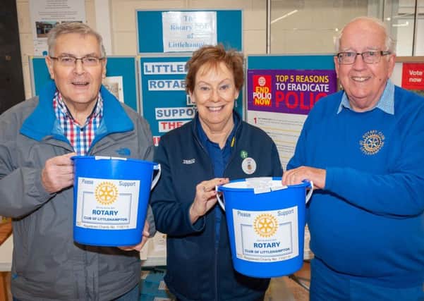 Geoff Watts, chairman of Littlehampton Rotary Club's community service committee, left, with Jill Bartlett, Tesco customer assistant, and club president Keith Green. Picture: Scott Ramsey