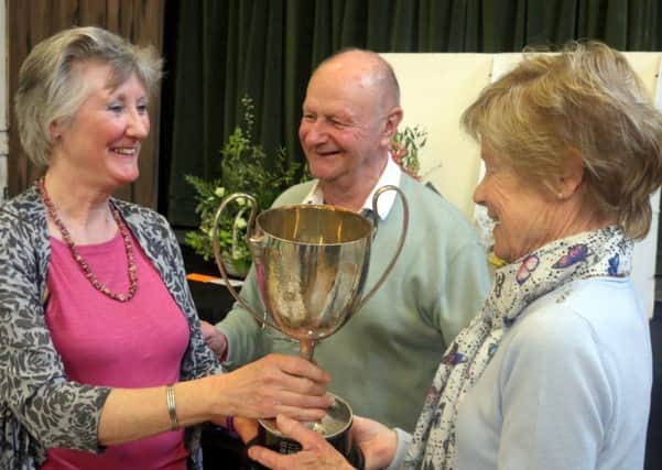 Val Hutton and Anne Dyball jointly receiving their cup from Richard Tabor SUS-180416-155858001