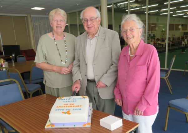 Jenny Radford, Alan Parsons and Mary Plastow cutting the anniversary cake