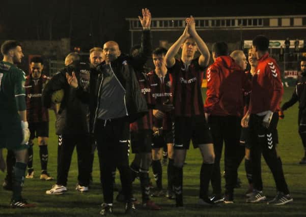 Lewes celebrate promotion after their victory against Horsham at the Dripping Pan