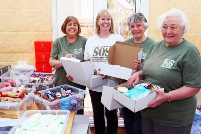 Packing parcels for armed forces serving overseas, Support Our Soldiers volunteers, from left,Penny Keen, Lesley Cunningham. Virginia de Claire and Heather Hodges. Picture: Derek Martin DM1842130a