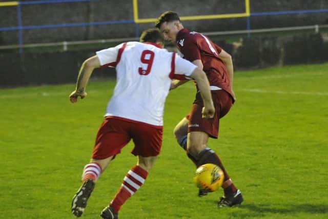 Little Common midfielder Liam Ward blocks the path of Langney Wanderers forward Wayne Wilkinson in last night's semi-final. Picture by Simon Newstead