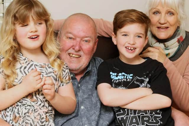 Bowel cancer survivor Charles Cushing with wife Anna and grandchildren Harvey Rawlinson, eight, and Evie Rawlinson, six.