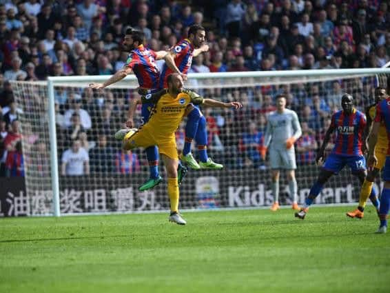 Glenn Murray jumps for a header. Picture by Phil Westlake (PW Sporting Photography)