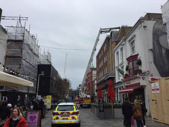 Emergency services rescue woman from Brighton roof