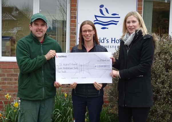 Emily Hackett and Graeme Banks give the cheque to Alex Burch