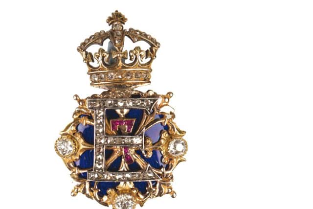 A gold, diamond, ruby and enamelled brooch in the form of the King's royal cypher, given by Edward VII to Lillie Langtry.