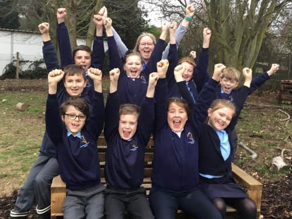 Eco TA, Karen Buncle, and pupils celebrate Southbournes Eco Schools silver award and good Ofsted rating