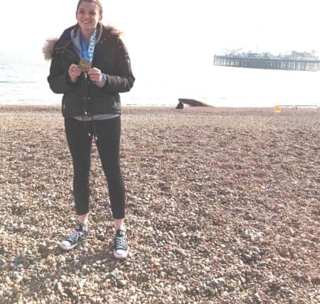 Tegan Page with her medal after completing the Brighton Marathon SUS-180417-094804001