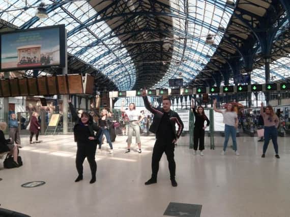 Greased Lightning! Dancers perform a flash mob at Brighton station