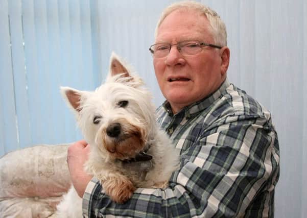 Roger Bathard's back was injured by two big dogs and wants to warn others. Pictured with his dog Evie. Photo by Derek Martin Photography