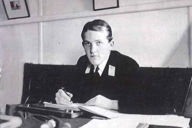 Midshipman Hordern in the gunroom, at work on his journal