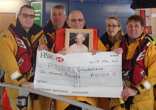 Graham Collins presents the bequest to coxswain Steve Smith, right, and second coxswain Simon Tugwell. Picture: Shoreham RNLI