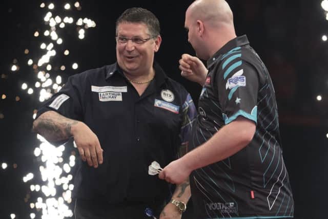 Rob Cross and Gary Anderson at the end of their match. Picture courtesy Lawrence Lustig/PDC