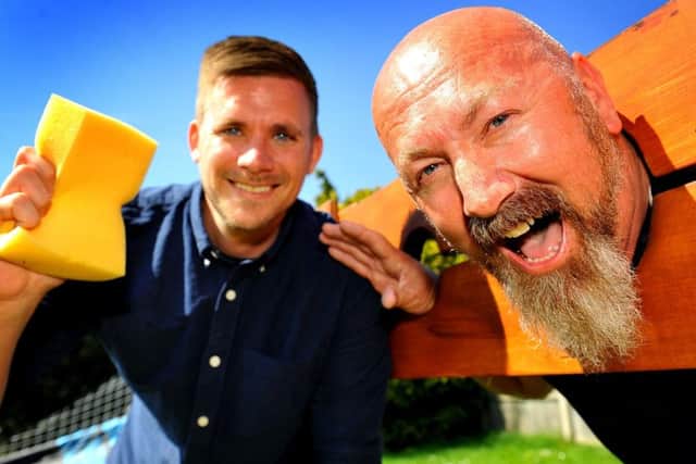 Team leader Chris Moore gets owner Andy Freeman in the stocks at the 15th anniversary party for Frontline Associates Supported Tenancies. Picture: Steve Robards SR1810401