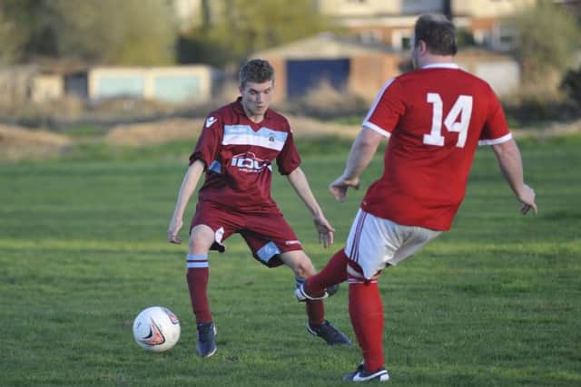 A Bexhill Town player passes the ball forward against Crowhurst.