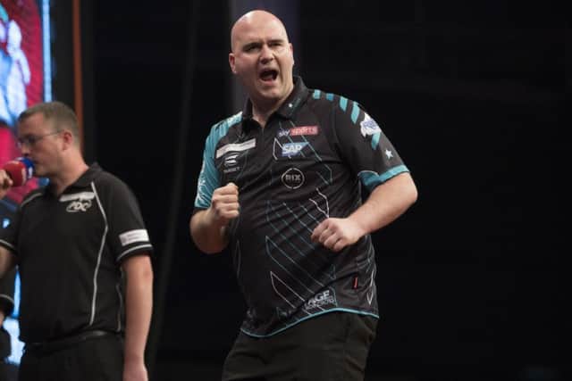 Rob Cross celebrates after a successful visit to the oche. Picture courtesy Lawrence Lustig/PDC