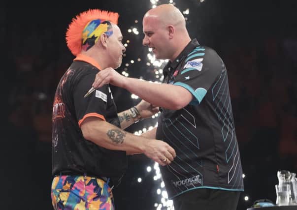 Rob Cross and Peter Wright in conversation at the end of the match. Picture courtesy Lawrence Lustig/PDC