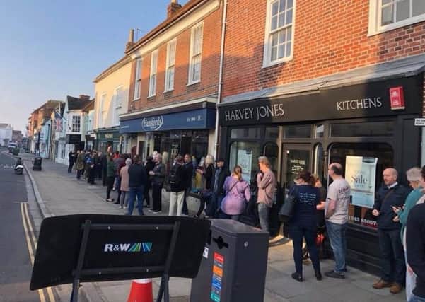 Customers queued up South Street waiting for the doors to open. Picture by Kevin Farrell