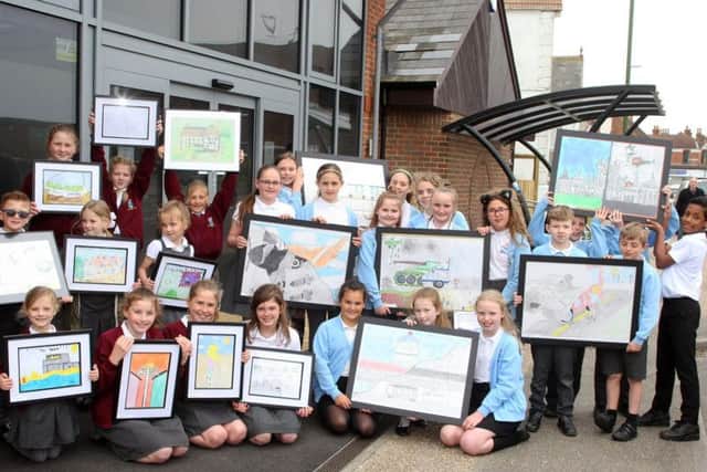 Pupils from Seaside Primary School, left, and The Globe Primary Academy outside New Pond Row Surgery in Lancing. Picture: Derek Martin DM1842771a