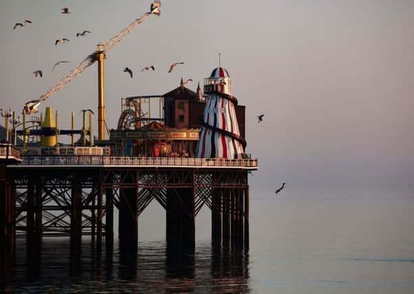 Two thrill-seekers somersaulting from the top of a helter skelter at the end of a pier (Credit: Sam Shaw/SWNS.com)