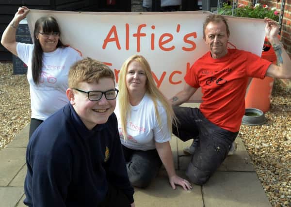 Alfie Spencer with mum Tracy (centre) and the rest of his support team at Alfies Tricycle. Picture: Kate Shemilt