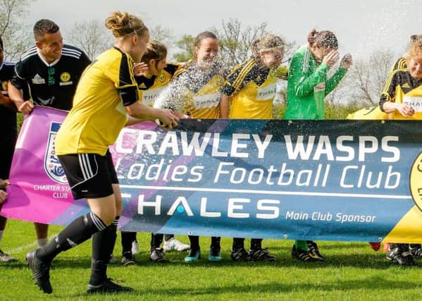 Crawley Wasps skipper Skipper Naomi Cole sprays the champagne as Crawley Wasps get the title party started
Picture: Ben Davidson  www.bendavidsonphotography.com SUS-180424-122058002