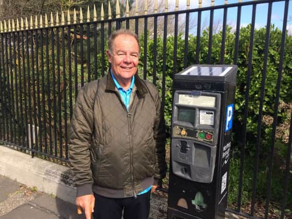 John Albon at one of the parking meters in Worthing