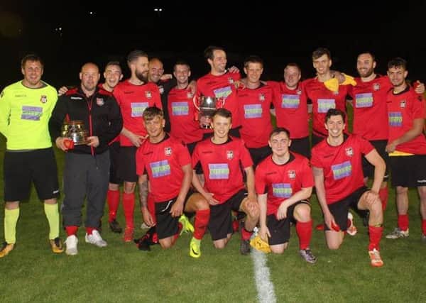 Rye Town Football Club celebrates after winning the Premier Travel Challenge Cup.