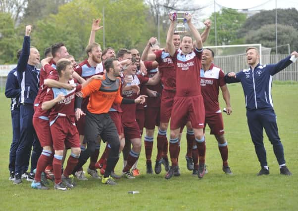 Little Common celebrate with the Macron Store Southern Combination Football League Division One trophy. Pictures by Simon Newstead