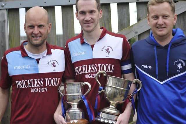 Little Common player-manager Russell Eldridge, captain Lewis Hole and Chris Eldridge with the club's two trophies.