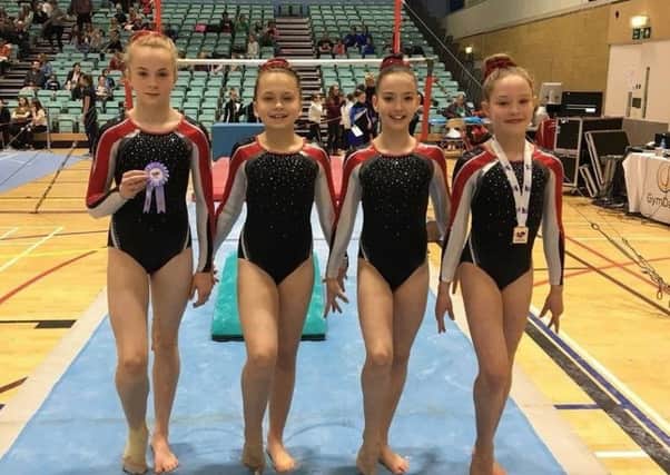 Four of the successful TAG gymnasts