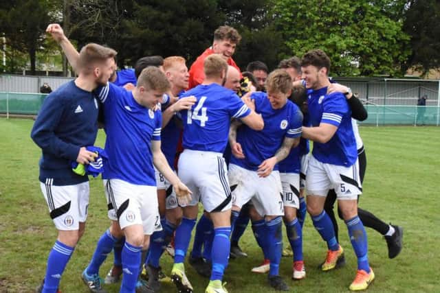 Heath celebrate winning the league on Saturday. Picture by Grahame Lehkyj