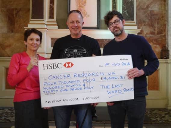 Val Barnes from Cancer Research UK, David Lindfield, event organiser, and Joel Penny from St Paul's at the cheque presentation