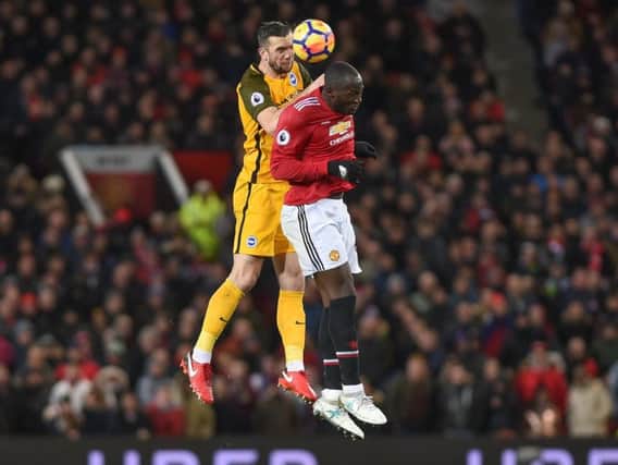 Shane Duffy wins a header against Romelu Lukaku during Albion's 1-0 Premier League defeat at Manchester United in November. Picture by Phil Westlake (PW Sporting Photography)