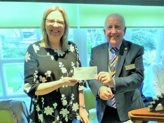 Keith Green, Rotary Club president, presenting the cheque to Lisa Wickens of Sussex Tornados
