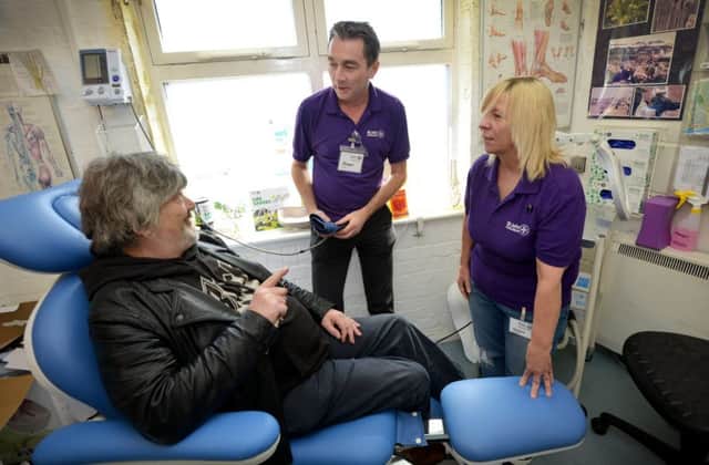Roger Nuttall and Debbie Hutchinson, of the St John Ambulance Hastings Homeless Service, speak with a patient. SUS-180205-094122001