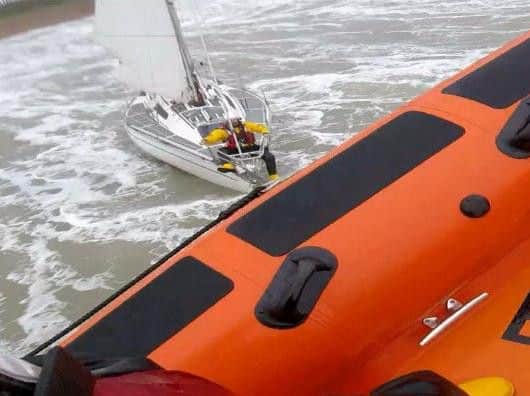 The Brighton crew take the stricken yacht under tow (Credit: RNLI/Brighton)