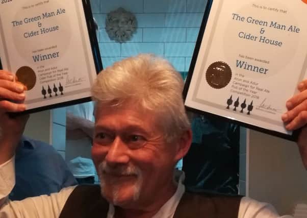 Les Johnson, landlord of The Green Man Ale and Cider House, with his two awards