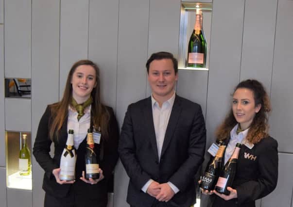 Edge Hotel School students Katie Renwick, left, and Elysabeth Yates with Pierre Darquey, account manager at Moet & Chandon
