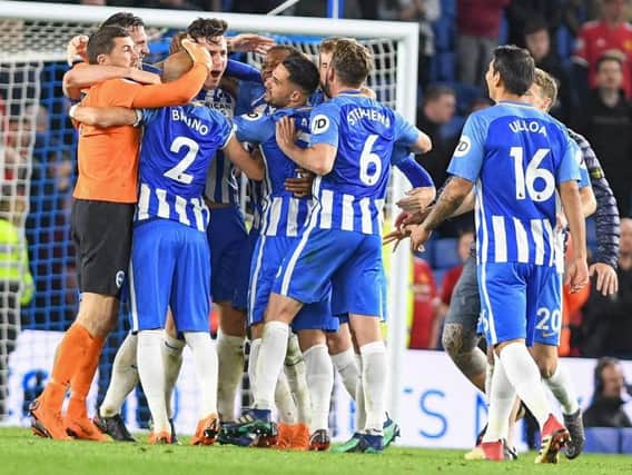 Lewis Dunk celebrates with his Albion team-mates after sealing Premier League survival. Picture by Phil Westlake (PW Sporting Photography)