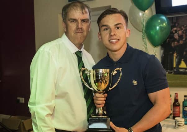 Calvin Davies picks up the fans' player of the year cup from Dave Seabourne / Picture by Tommy McMillan