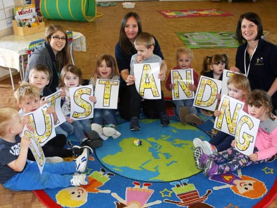 Staff and children at Little Rascals celebrate their outstanding Ofsted report