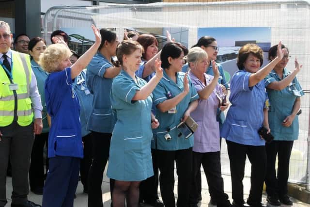 Staff waving HRH off after her visit