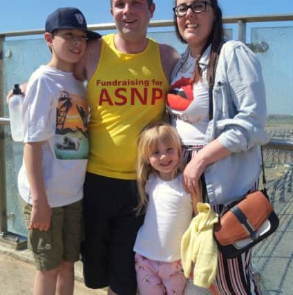 Chris Whittington with his family after completing the run