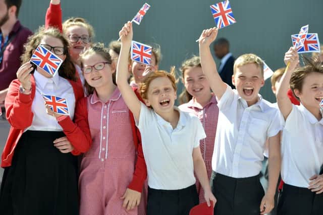 Children waved Union Jacks in celebration as the Royal arrived (photo by Peter Cripps)