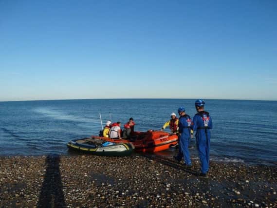 Selsey RNLI volunteers rescued three men in an inflatable boat being swept out to sea from East Beach on Saturday.