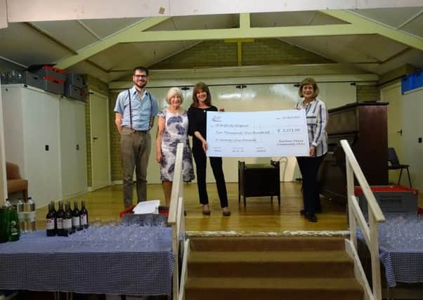 Harbour voices present cheque to St Wilfrids